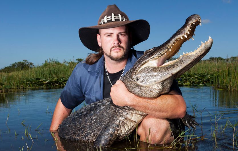 gator brian hugging an alligator in a swamp